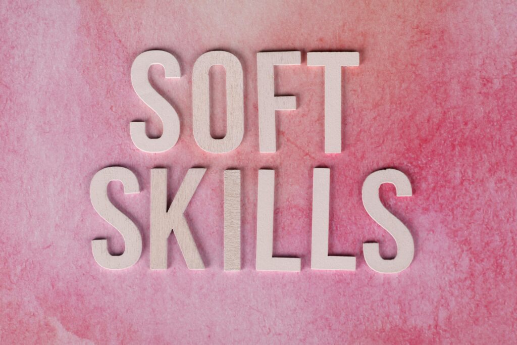 Text 'Soft Skills' on a pink watercolor background for educational and business themes.