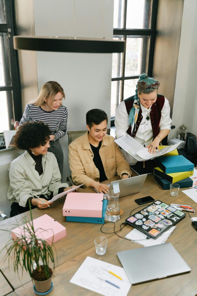 A diverse group of colleagues working together on a project in a modern office setting.